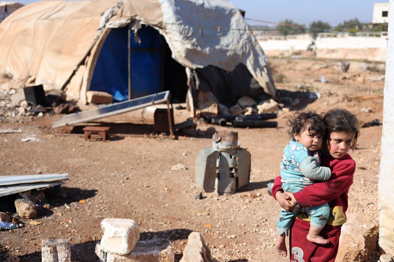 about-02 A touching scene of children in a refugee camp in Idlib, Syria, highlighting resilience.